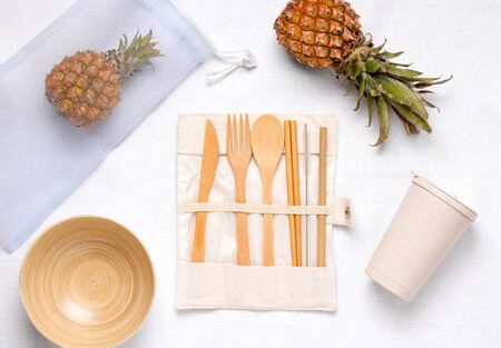 on a white table are kitchen utensils made of wood and a shopping bag. Zero Waste Cleaningの写真素材