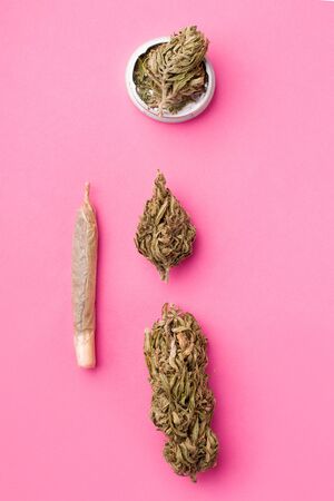 hemp on a pink background next to a cigarette. vertical photo of marijuanaの写真素材