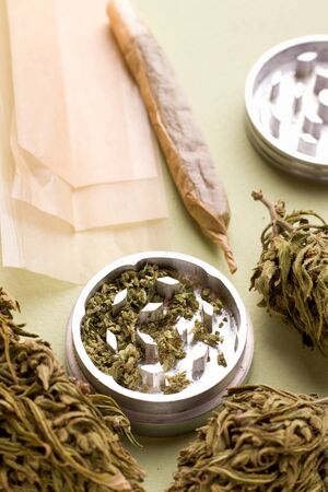 Marijuana close-up in a vertical orientation. next cannabis cigarette and chopped marijuanaの写真素材