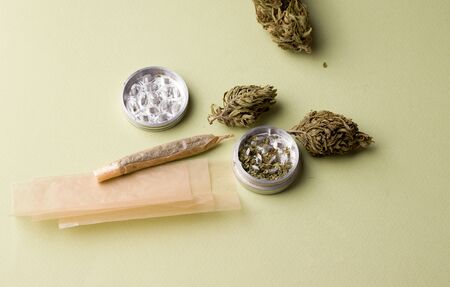 marijuana bump with a jamb and grinder on a green backgroundの写真素材