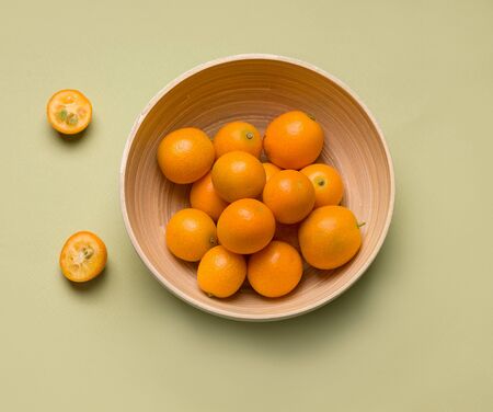 kumquat fruit in Minsk from bamboo on a green background close-upの写真素材