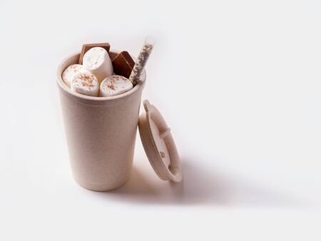 Reusable cup with sweet yrshmelo and chocolate on a white background. copy spaceの写真素材