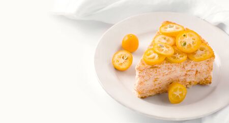 dessert sweet cake decorated with slices of kumquat tropical fruit on white onet. copy spaceの写真素材