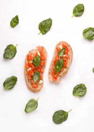 Bruschetta - a traditional Italian dish with tomato, garlic and basil on toastの写真素材