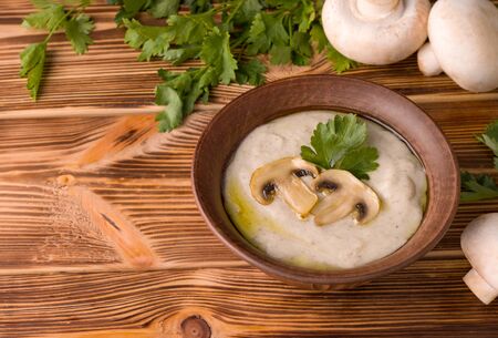 traditional jewish dish cream champignon soup on a wooden table. copy spaceの写真素材