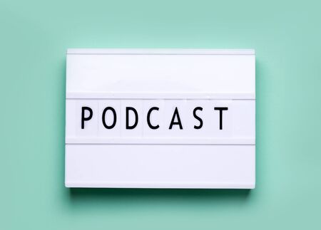 lightbox white board on a mint color background with the words podcastの写真素材