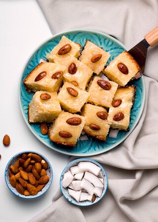 oriental confectionery based on semolina arabic Busbus pie poured with syrup on a white background close-upの写真素材