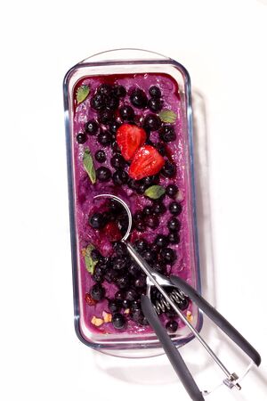 frozen sorbet from berries and ube on a white background. vertical photoの写真素材