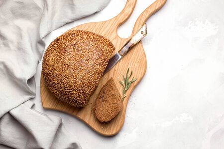round bread with sesame seeds on a white background. copy spaceの写真素材