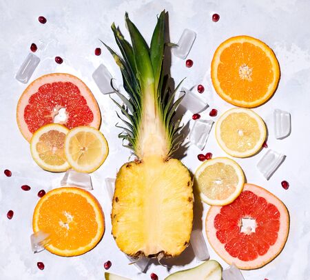 Summer tropical fruits pineapple, grapefruit, orange, lemon on a concrete background.の写真素材