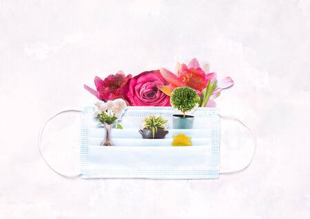 collage with a protective mask in which flowers. quarantine gardening conceptの写真素材