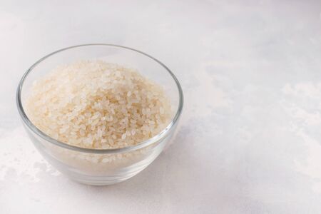 rice in a glass bowl on a white background. copy spaceの写真素材