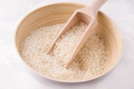 close-up rice in a bamboo bowl on a white backgroundの写真素材