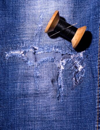 sewn blue jeans next to black threads. concept boroの写真素材