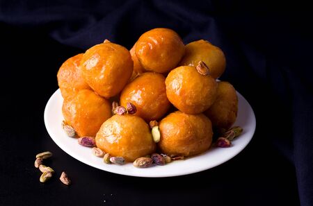 Arab sweet desserts for lokma post on a black background.の写真素材