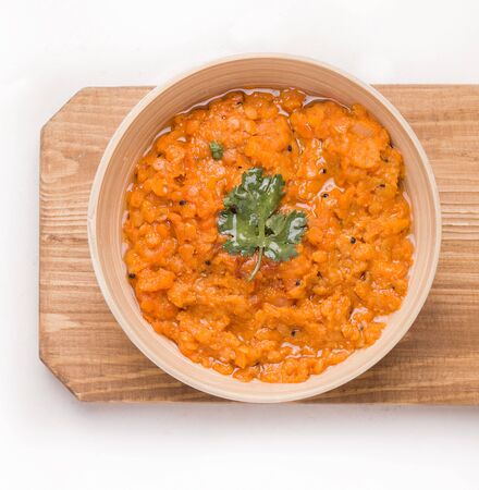 Dhal Indian cream lentil soup in a plate on a wooden boardの写真素材