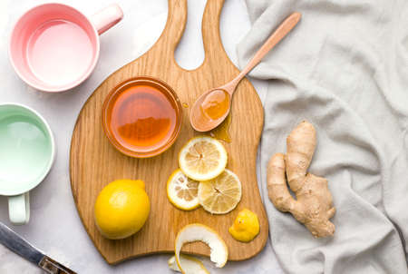 Healthy food. Lemon in a jar with honey and ginger on a white background. Copy spaceの写真素材