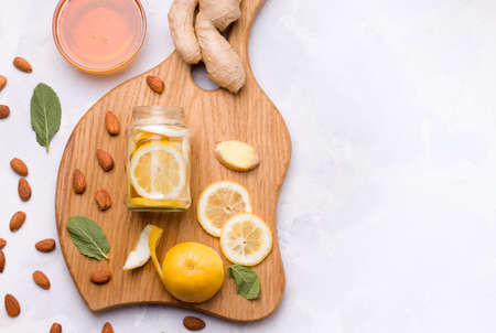 Healthy food. Lemon in a jar with honey and ginger on a white background. Copy space