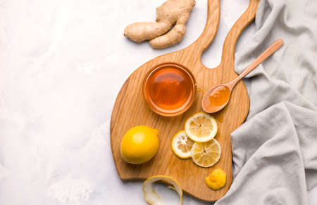 Healthy food. Lemon in a jar with honey and ginger on a white background. Copy spaceの写真素材