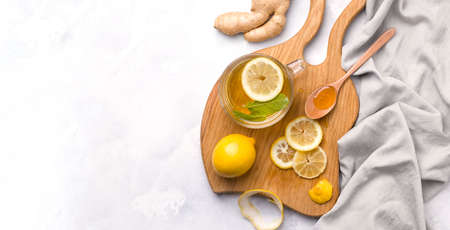 Healthy food. Lemon in a jar with honey and ginger on a white background. Copy spaceの写真素材