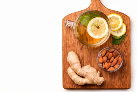 useful tea with lemon, ginger and mint on a white background copy spaceの写真素材