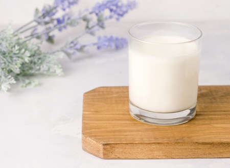 Fermented kefir drink in a glass on a wooden board on a white background. Rusticの写真素材