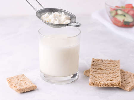 Strained milk of kefir grain. Fermented fermented milk drink in a glass.の写真素材