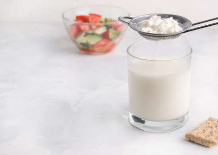 Fermented milk product drink kefir in a glass on a white background. Healthy breakfast conceptの写真素材