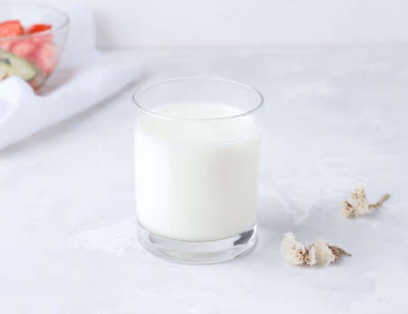 The concept of fermented drinks. Milk kefir in a glass on a concrete background. Healthy foodの写真素材