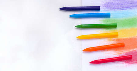 The concept of drawing lessons. Crayons of different colors on a white background. Copy spaceの写真素材