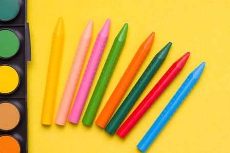 Crayons and paints on a yellow background. Drawing conceptの写真素材