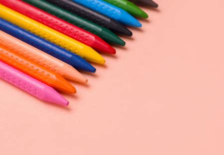 Pencils for drawing different colors on a beige background. Copy space.