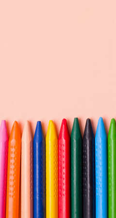 Creativity concept. Crayons on nude background. Copy space. Vertical photoの写真素材