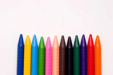 Drawing concept. Chalks of different colors on a white paper. Copy spaceの写真素材