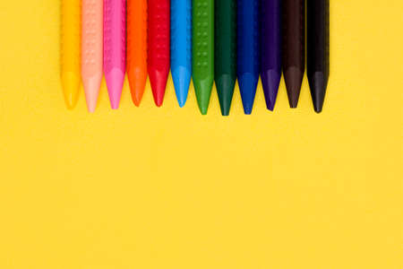 The concept of children's creativity. Crayons on a yellow background. Copy spaceの写真素材