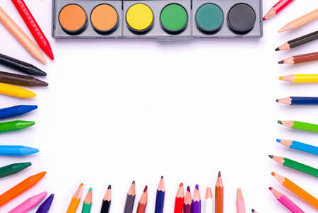 The concept of children's creativity, drawing. Paints and crayons and pencils on a white background. Copy spaceの写真素材