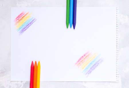 Chalks of different colors on a white paper. Copy space. Drawing lessons, school.の写真素材