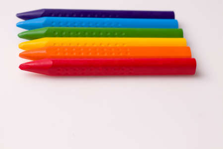 Chalks of different colors on white paper. Copy space. The concept of children's creativity and drawing lessonsの写真素材
