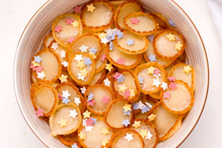 Breakfast tiny pancake cereal for children with powder close-upの写真素材