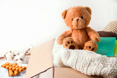 Concept of donation, sending care. In the box are things, stationery, vitamins and toysの写真素材