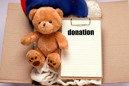 Box with donations in which a teddy bear, things and blank