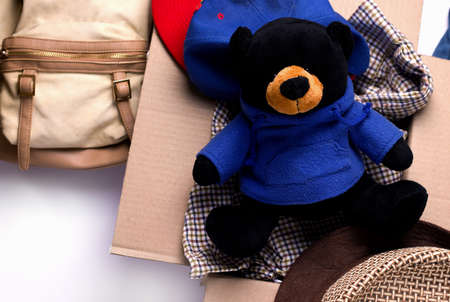 Things, a backpack, a toy in a box. Copy space