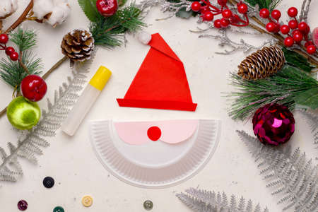 Do it yourself at Christmas. Walkthrough. Step Two Stick pieces of paper on half a plastic plate.の写真素材