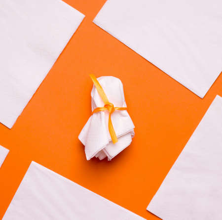 DIY Halloween candy ghost step by step. Image three. Wrap the candy and tie it with ribbon