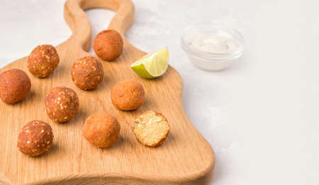 A Middle Eastern dish of falafel. Fried balls on a wooden board. Copy spaceの写真素材