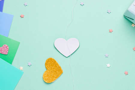 Diy card with a rotating heart for the holiday step by step. Step two glue the thread on the heart on the figure that will rotate.の写真素材