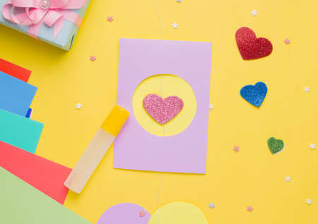Diy card with a rotating heart for the holiday step by step. Step five. Place a cardboard box on top with a hole identical to the outside of the postcardの写真素材