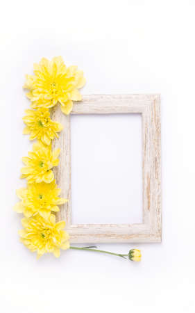 mock up in a wooden frame on a white background, next to yellow flowers. Summer compositionの写真素材
