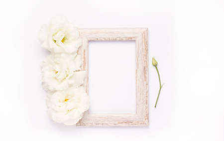 Wooden photo frame with white flowers. Copy spaceの写真素材