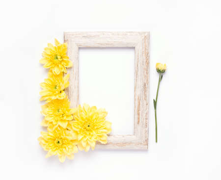 mock up empty wooden frame with yellow flowers on white backgroundの写真素材